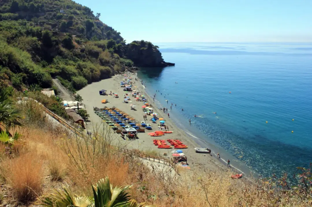 Maro beach, a cove with crystal-clear water surrounded by cliffs