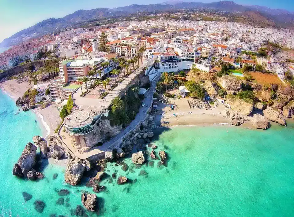 Aerial view of the Balcón de Europa and Nerja's coves with turquoise water